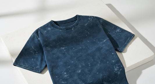 Acid washed navy blue t-shirt on a white background