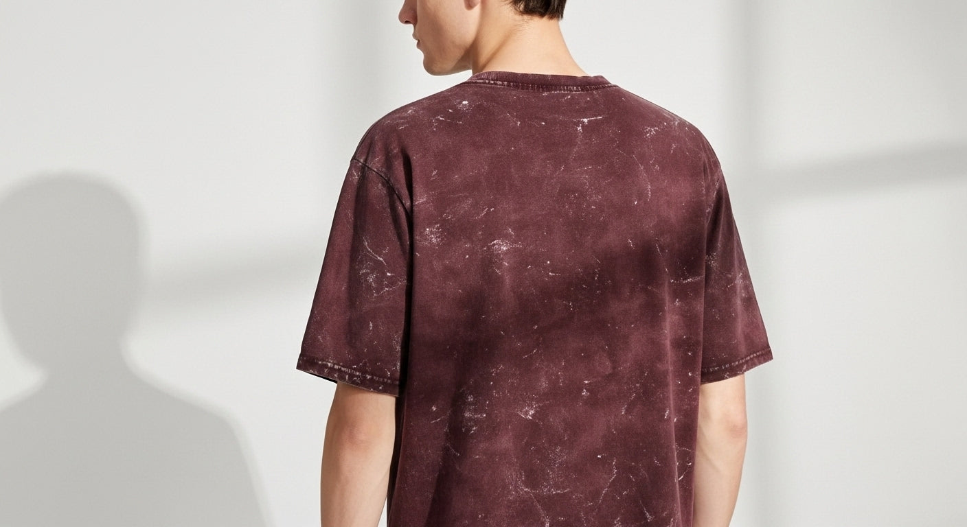 Person wearing a maroon t-shirt with a white background