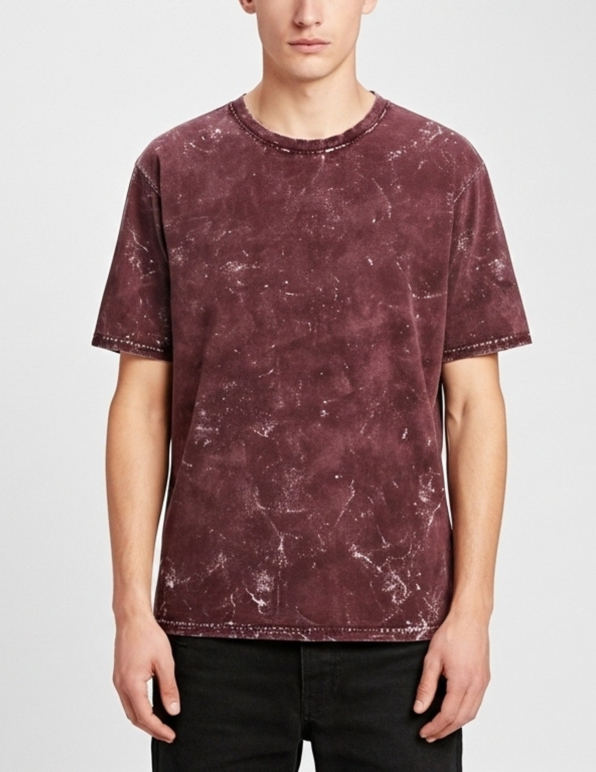 Person wearing a maroon t-shirt with a white background