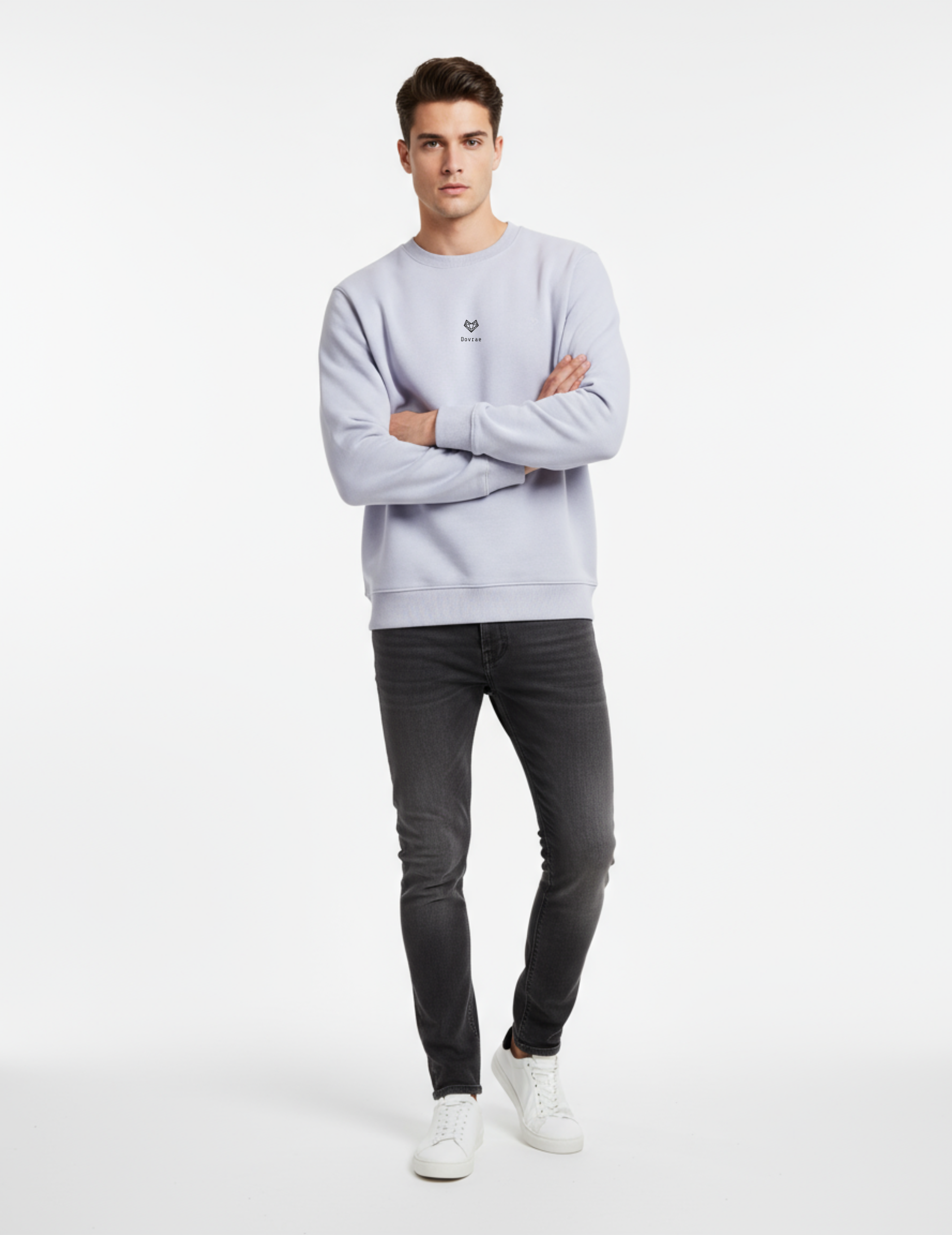 Man wearing a Lavender sweatshirt and dark jeans standing against a white background
