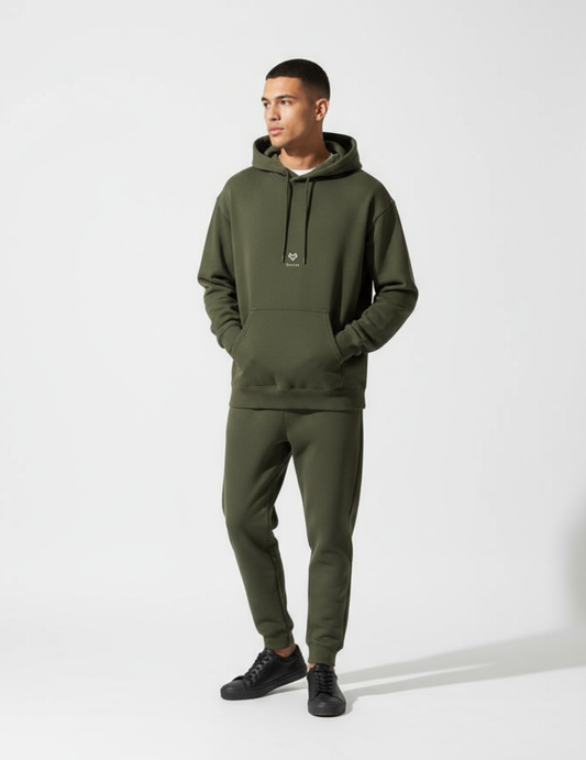Man wearing a green hoodie and jogger pants on a white background