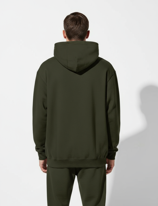Person wearing a green hoodie and pants on a white background
